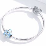 Ezüst charm, bőrönd